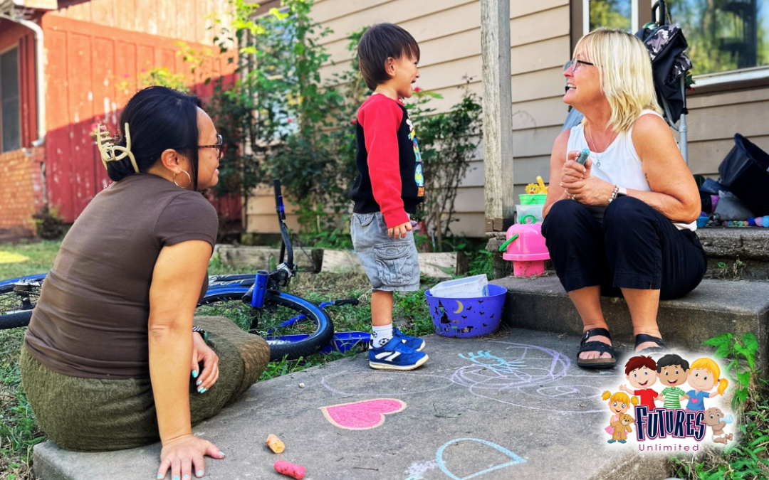 Our home visitor is visiting a child on their porch steps while the child's mom looks on